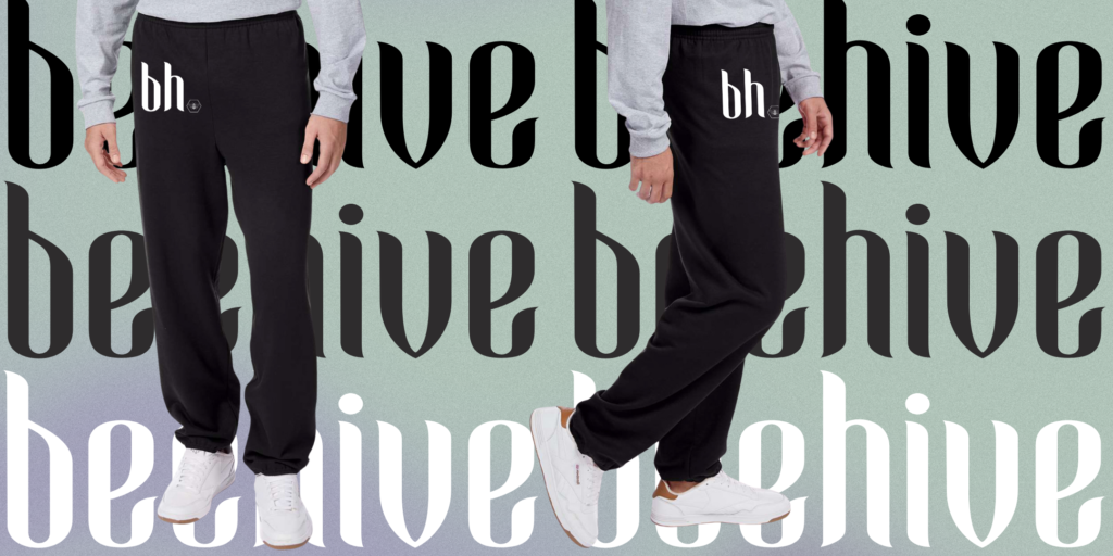 Black sweatpants with a minimalist ‘bh’ logo and honeycomb detail on the upper thigh. The background features a soft green-to-purple gradient with bold ‘beehive’ text layered throughout for a modern, stylish vibe.